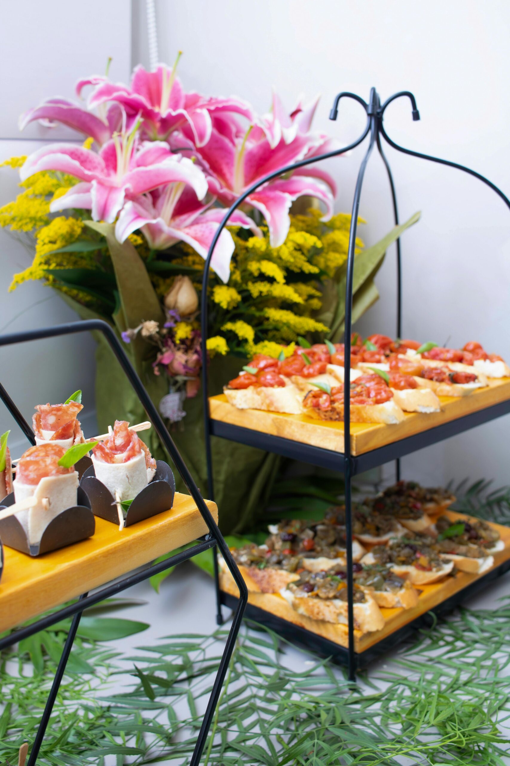 Home Chic catering setup featuring gourmet appetizers and vibrant floral decor, perfect for events.